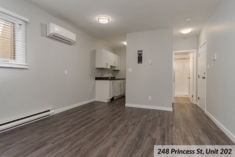 the living room and kitchen of an apartment